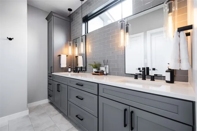 a bathroom with a granite countertop sink a mirror a vanity and shower