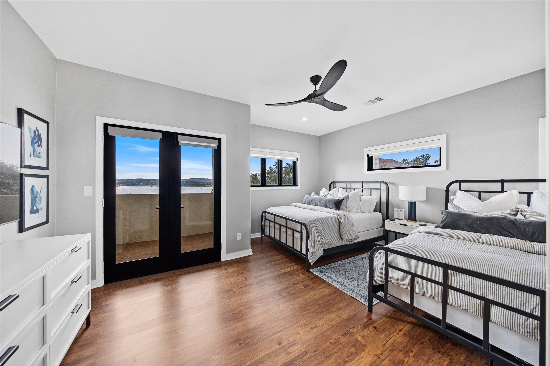 516 Deckhouse Drive Point Venture, TX 78645 - Photo 23 of 36 a bedroom with two beds and a large window