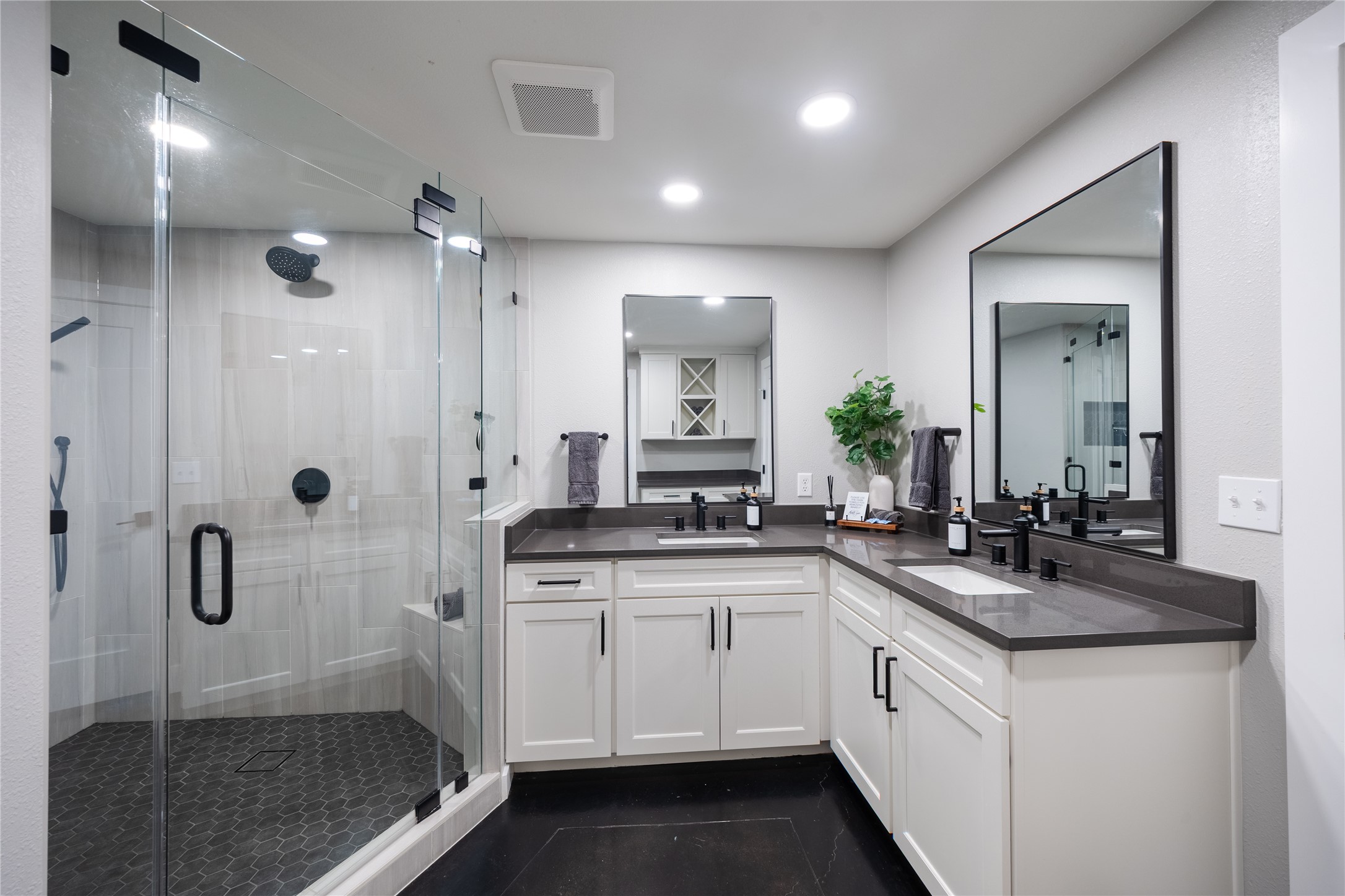 516 Deckhouse Drive Point Venture, TX 78645 - Photo 28 of 36 a bathroom with a granite countertop sink a mirror a vanity and shower
