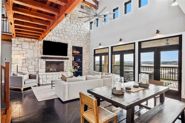 a kitchen with stainless steel appliances a stove a sink a microwave a dining table and chairs