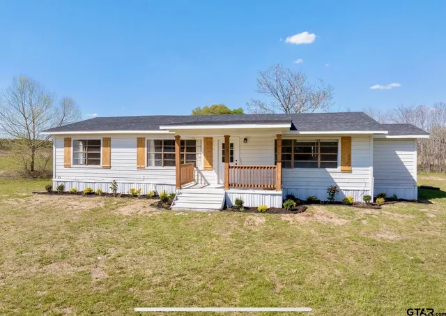 a view of a house with a yard and mountain