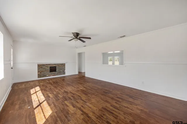 wooden floor in an empty room with a window