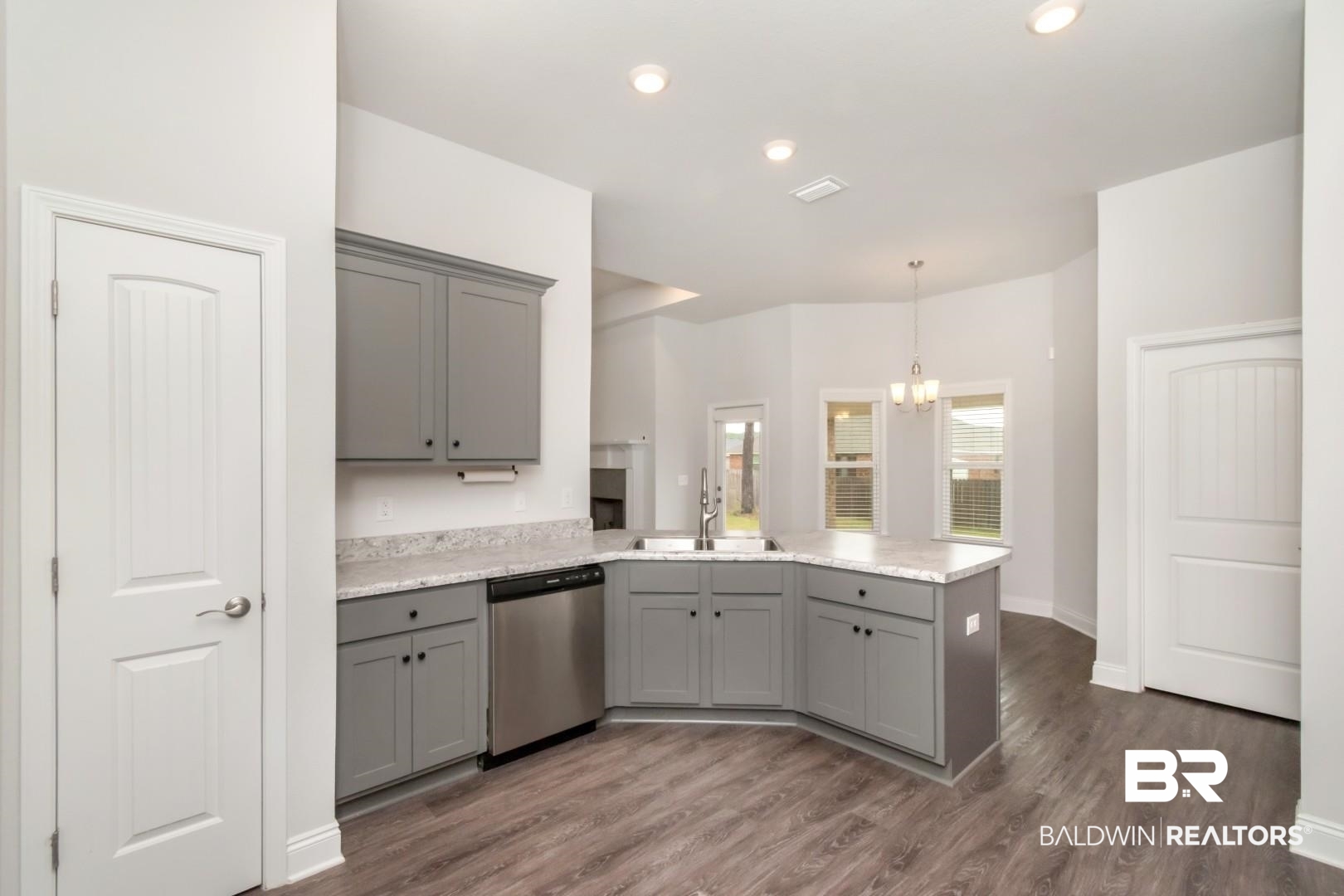 6632 Monarch Circle Mobile, AL 36618 - Photo 9 of 32 Kitchen featuring gray cabinets, a peninsula, dishwasher, dark wood-style flooring, and hanging lights