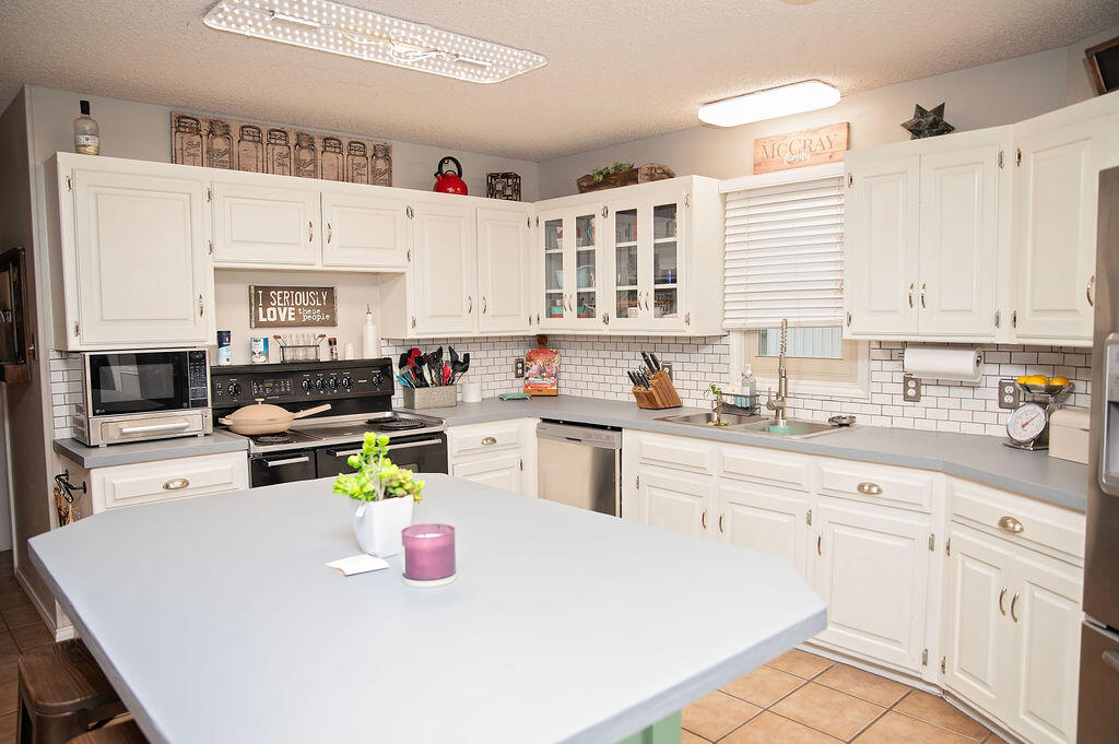 2917 Quail Ridge Road Denver City, TX 79323 - Photo 11 of 55 a kitchen with a white cabinets and white appliances