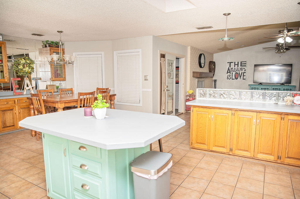 2917 Quail Ridge Road Denver City, TX 79323 - Photo 12 of 55 a kitchen with a sink a stove a dining table and chairs
