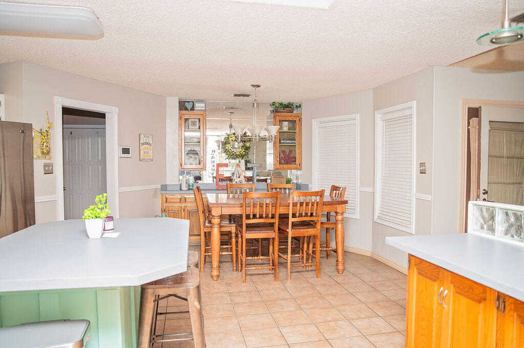 2917 Quail Ridge Road Denver City, TX 79323 - Photo 13 of 55 a dining room with furniture a window and kitchen view