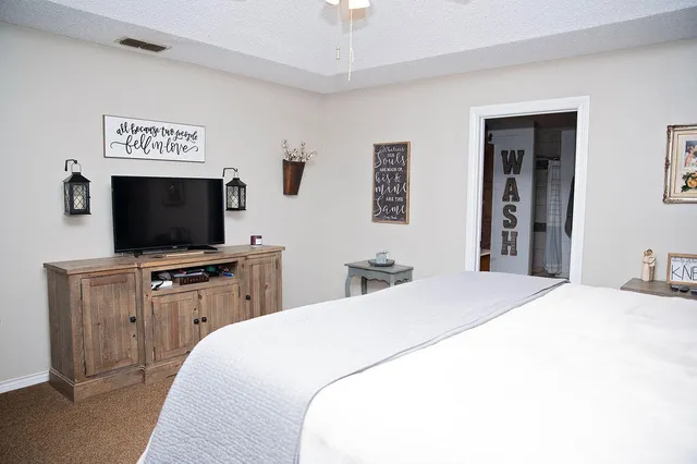 a bedroom with a bed and a dresser