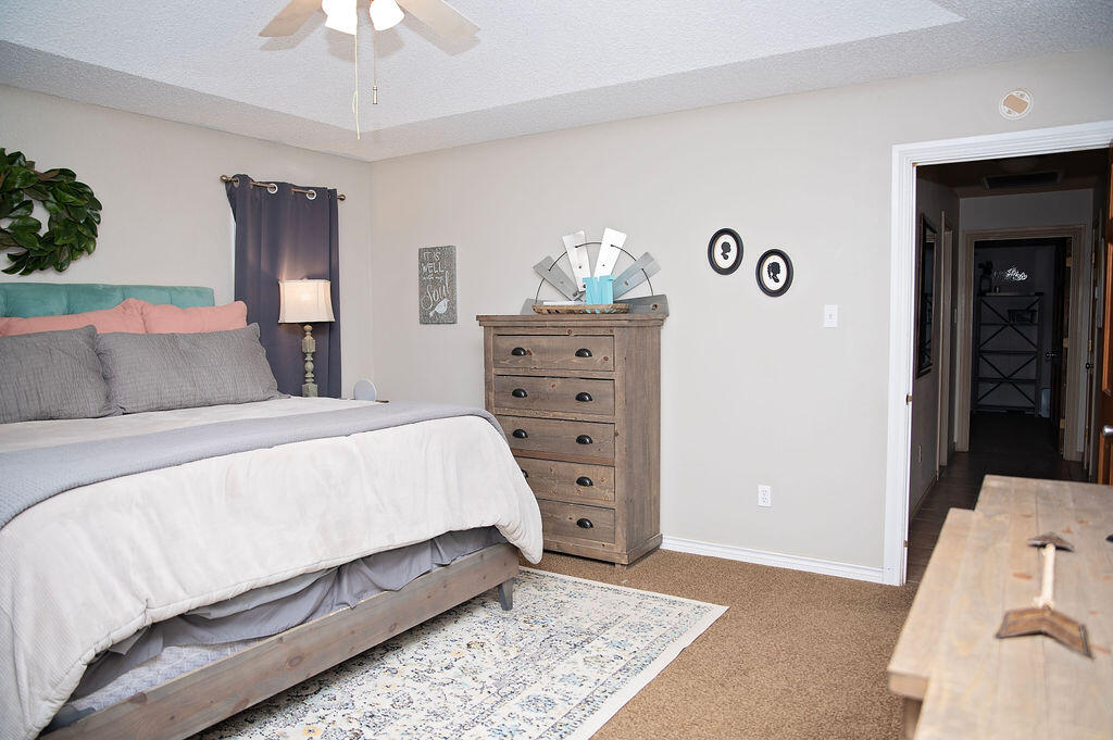 2917 Quail Ridge Road Denver City, TX 79323 - Photo 16 of 55 a bedroom with a bed and a dresser