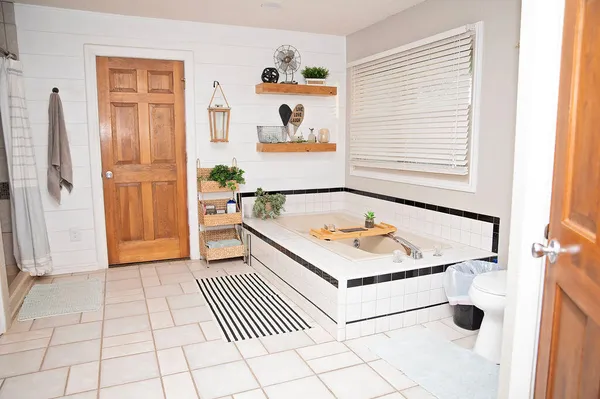 a bathroom with a sink a mirror and a shower