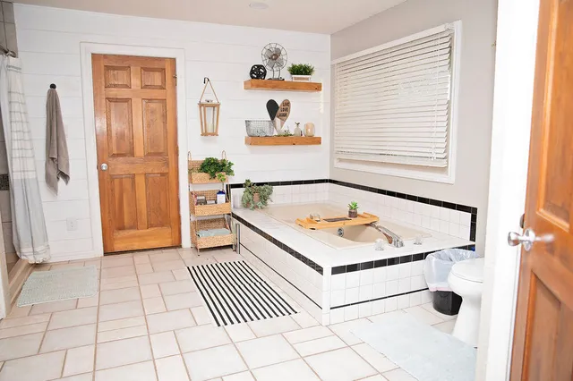 a bathroom with a sink a mirror and a shower