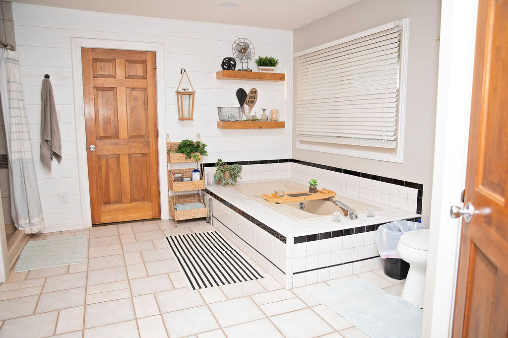 2917 Quail Ridge Road Denver City, TX 79323 - Photo 17 of 55 a bathroom with a sink a toilet and a window