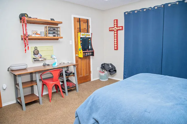 a bedroom with a bed and a dresser