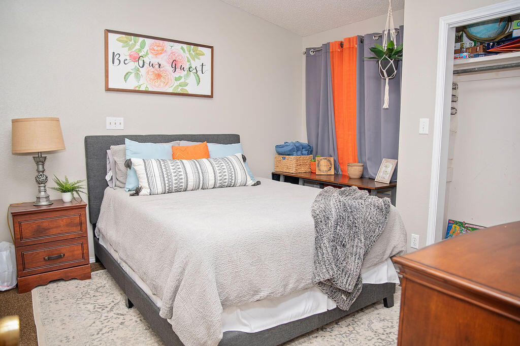 2917 Quail Ridge Road Denver City, TX 79323 - Photo 26 of 55 a bedroom with a bed and a dresser