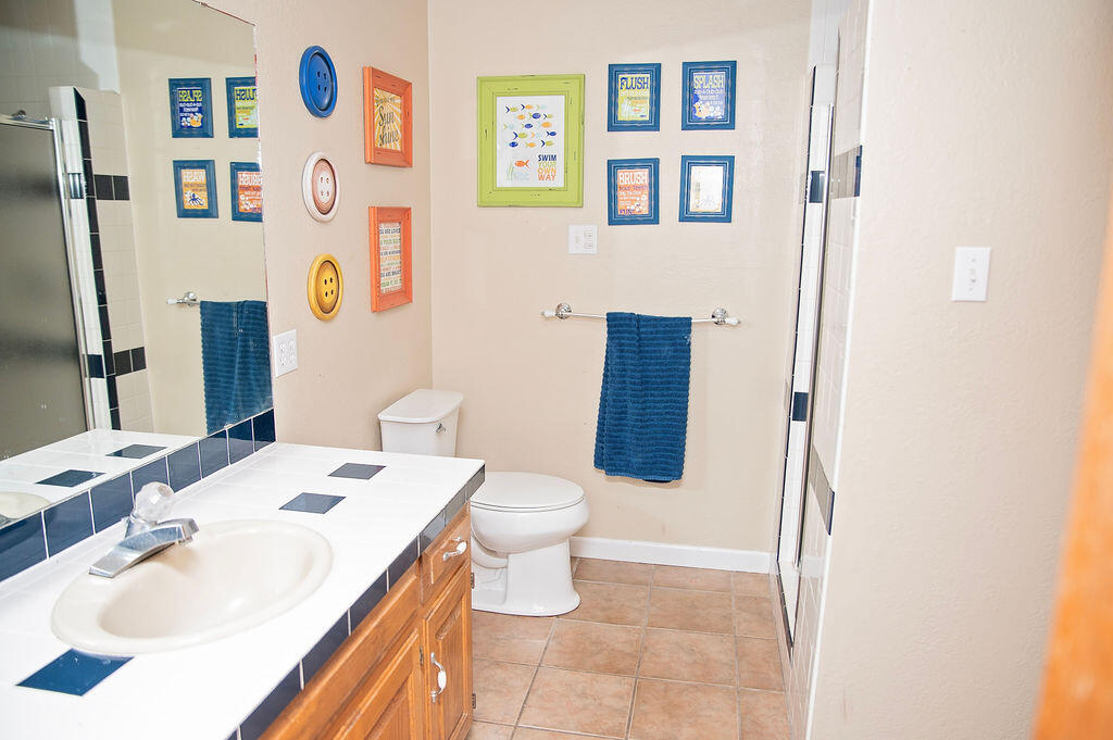 2917 Quail Ridge Road Denver City, TX 79323 - Photo 28 of 55 a bathroom with a sink toilet and vanity
