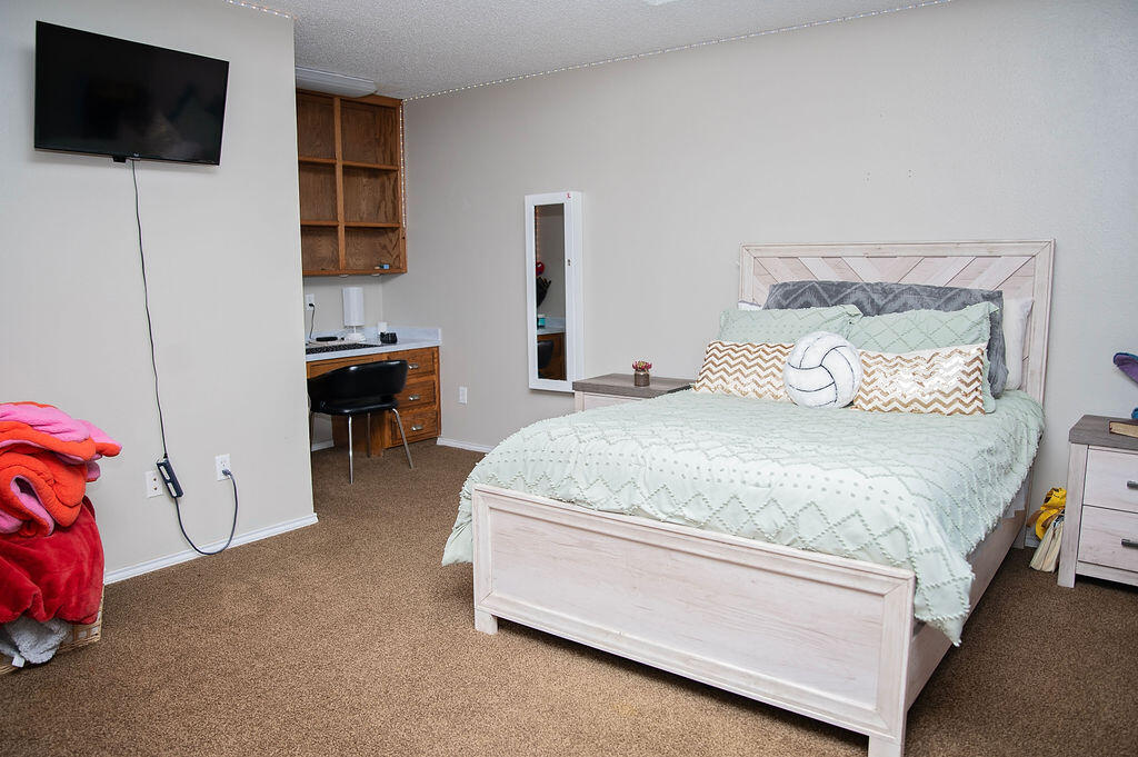 2917 Quail Ridge Road Denver City, TX 79323 - Photo 29 of 55 a bedroom with a bed and a flat screen tv