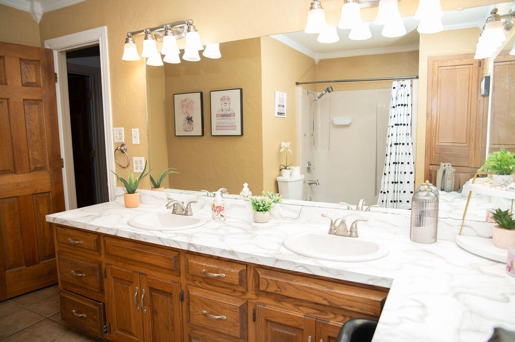 2917 Quail Ridge Road Denver City, TX 79323 - Photo 32 of 55 a bathroom with a granite countertop sink and a mirror