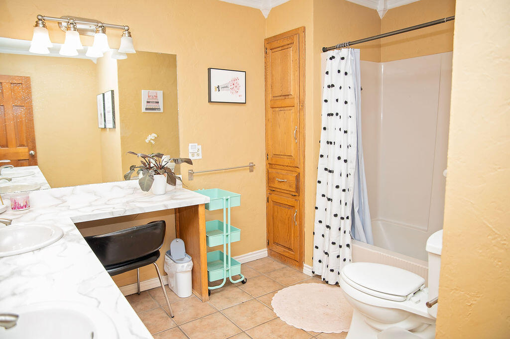 2917 Quail Ridge Road Denver City, TX 79323 - Photo 33 of 55 a bathroom with a sink toilet and shower