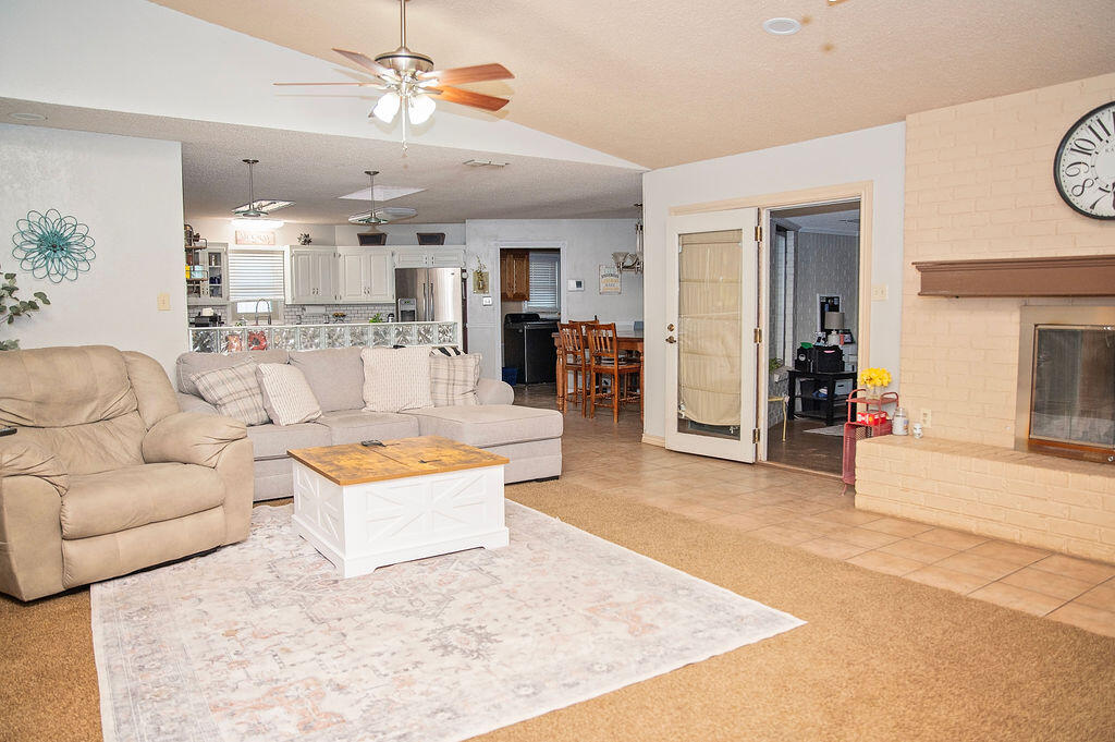 2917 Quail Ridge Road Denver City, TX 79323 - Photo 5 of 55 a living room with furniture and a chandelier