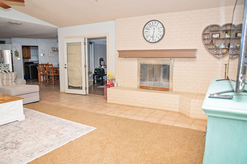2917 Quail Ridge Road Denver City, TX 79323 - Photo 6 of 55 a living room with a clock and a fireplace