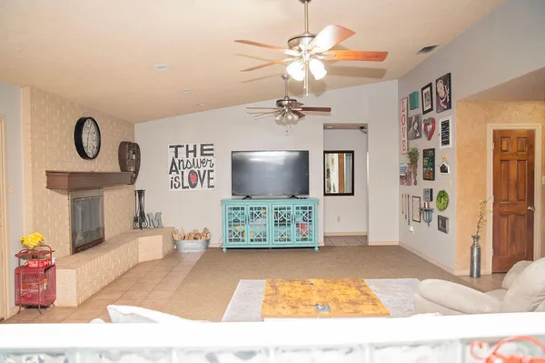 a kitchen with stainless steel appliances a white refrigerator a sink a stove a dining table and chairs