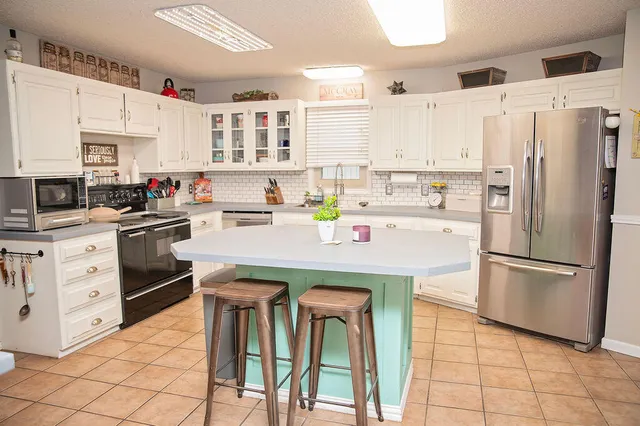 a kitchen with a white cabinets and white appliances