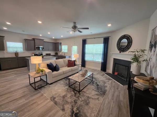 a living room with furniture a fireplace and a flat screen tv