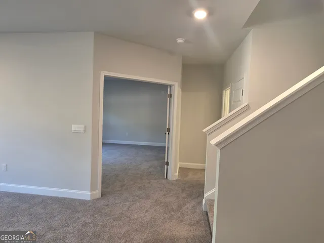 a view of an empty room with stairs