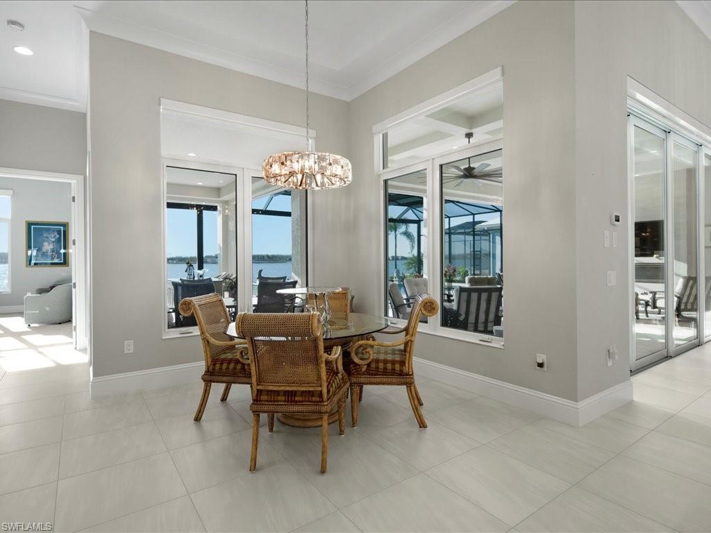 18460 Blue Eye Loop Fort Myers, FL 33913 - Photo 11 of 50 a view of a dining room with furniture and a chandelier