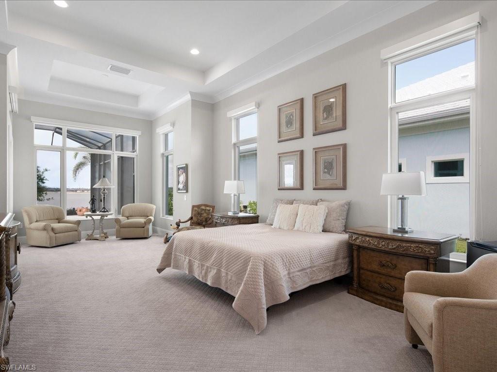 18460 Blue Eye Loop Fort Myers, FL 33913 - Photo 13 of 50 a spacious bedroom with a bed and glass windows