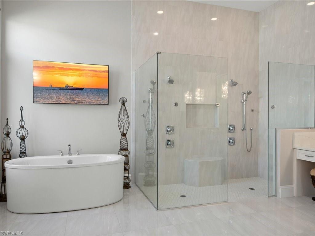 18460 Blue Eye Loop Fort Myers, FL 33913 - Photo 16 of 50 a bathroom with a white bath tub a shower and a sink