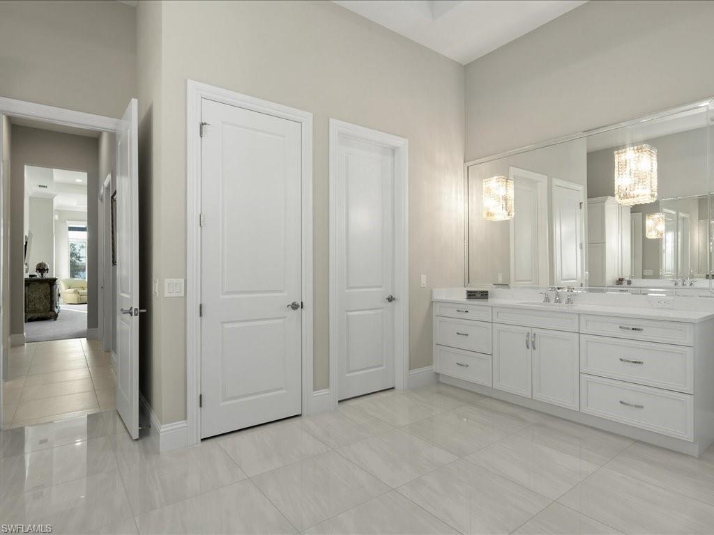 18460 Blue Eye Loop Fort Myers, FL 33913 - Photo 17 of 50 a spacious bathroom with a granite countertop sink mirror and a