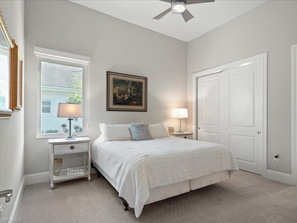 18460 Blue Eye Loop Fort Myers, FL 33913 - Photo 19 of 50 a bedroom with a bed and a chandelier