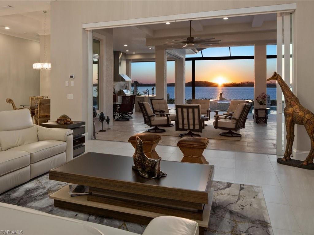 18460 Blue Eye Loop Fort Myers, FL 33913 - Photo 2 of 50 a living room with patio furniture and a floor to ceiling window