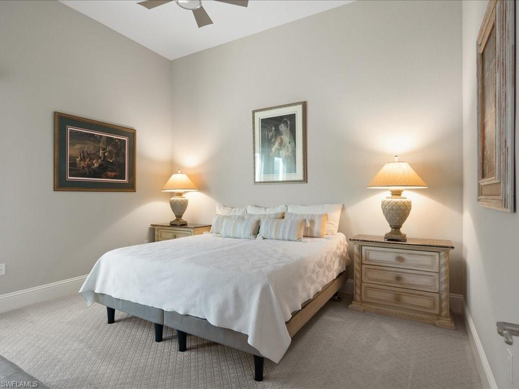 18460 Blue Eye Loop Fort Myers, FL 33913 - Photo 21 of 50 a bedroom with a bed and a lamp on table