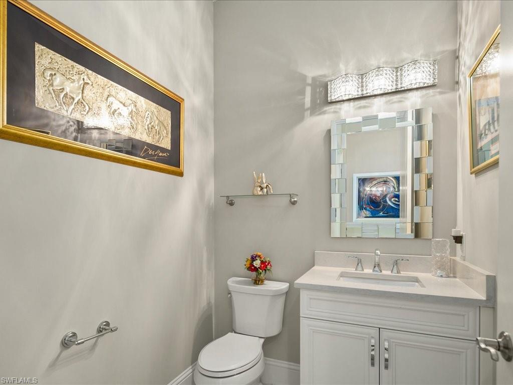 18460 Blue Eye Loop Fort Myers, FL 33913 - Photo 28 of 50 a bathroom with a toilet a sink and a mirror