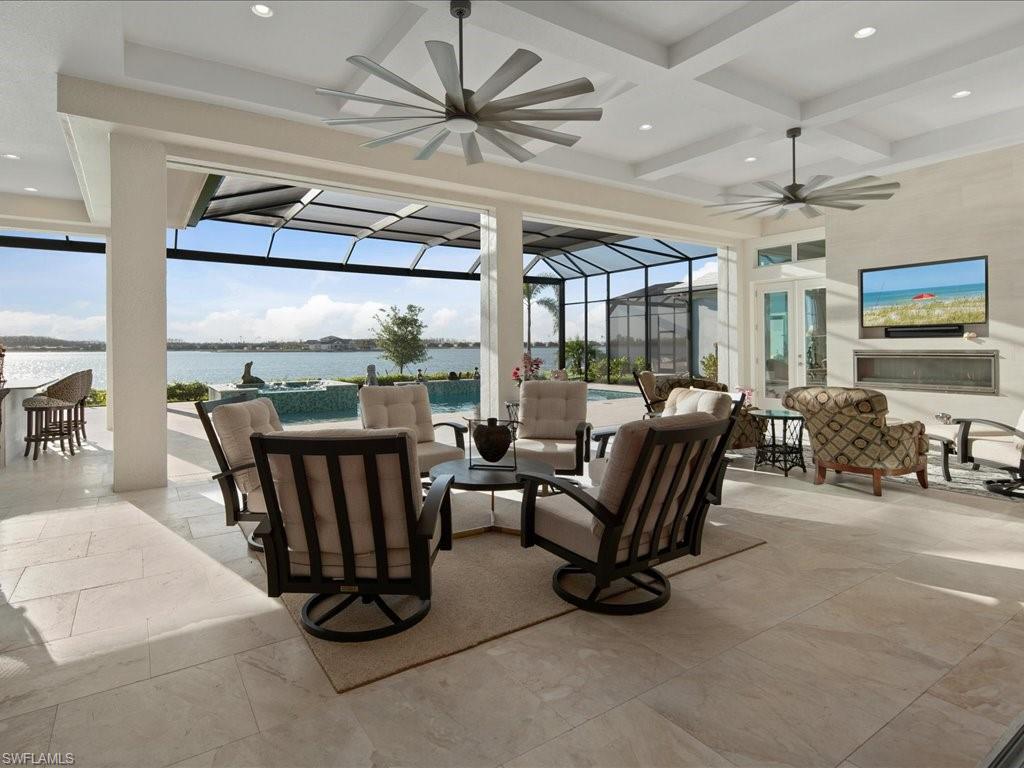 18460 Blue Eye Loop Fort Myers, FL 33913 - Photo 3 of 50 a living room with furniture a flat screen tv and a large window