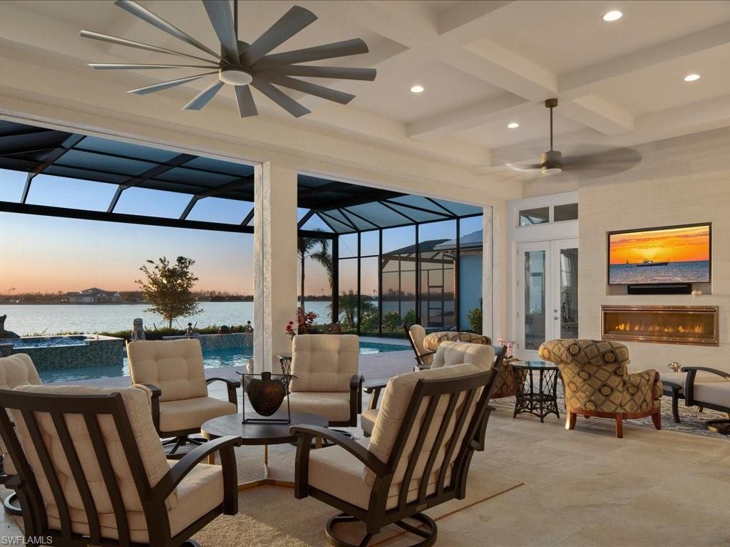 18460 Blue Eye Loop Fort Myers, FL 33913 - Photo 35 of 50 a living room with furniture a ceiling fan and a flat screen tv