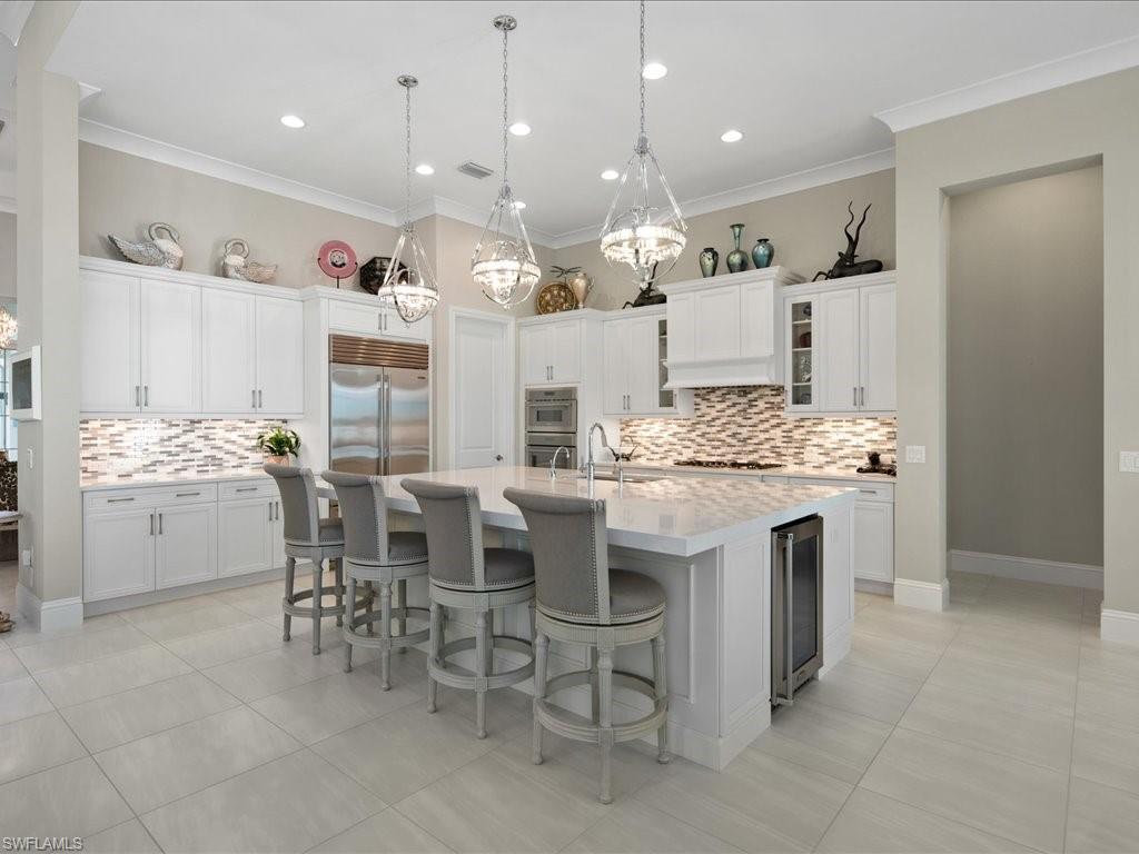 18460 Blue Eye Loop Fort Myers, FL 33913 - Photo 5 of 50 a kitchen with kitchen island granite countertop a sink and a refrigerator