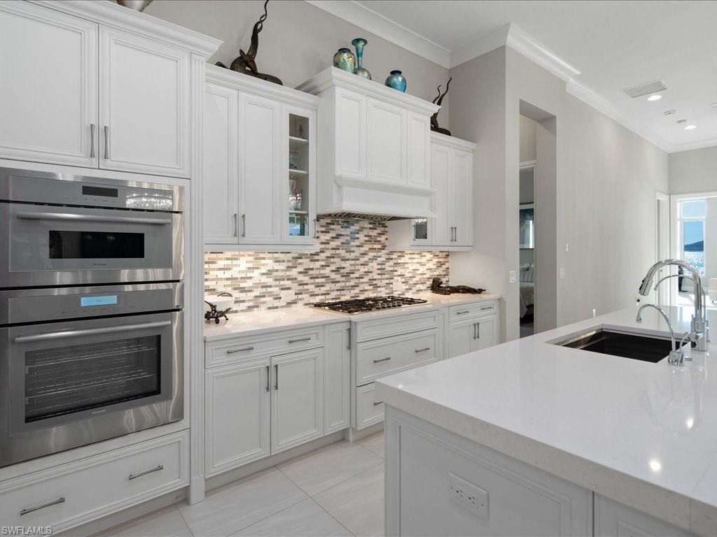 18460 Blue Eye Loop Fort Myers, FL 33913 - Photo 6 of 50 a kitchen with granite countertop white cabinets and white stainless steel appliances