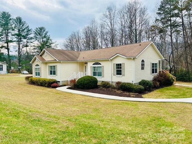 185 Creasman Hill Road Mills River, NC 28759 - Photo 1 of 5 a front view of a house with yard and green space