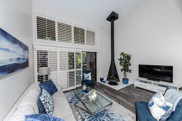 a living room with furniture and a potted plant