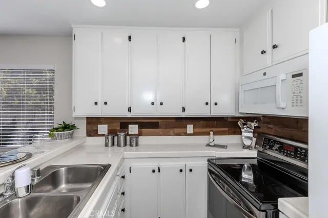 a kitchen that has a sink and a stove