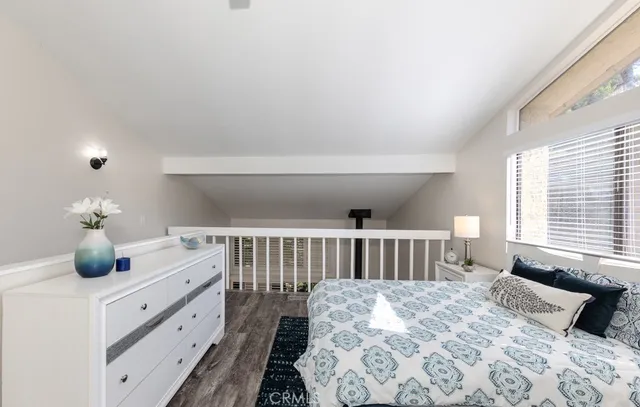 a view of a bathroom with a granite countertop sink a mirror and a potted plant