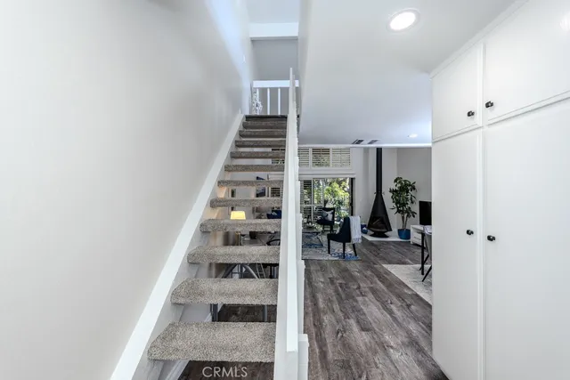 a kitchen with white cabinets and window