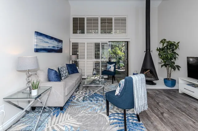 a living room with furniture and a potted plant