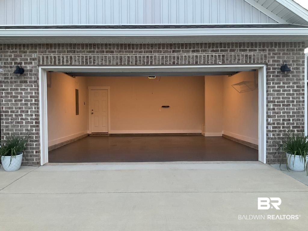 1093 Pheasant Circle Foley, AL 36535 - Photo 3 of 25 Garage featuring driveway and electric panel