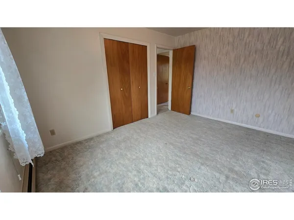 a open area with a cabinet and bathroom