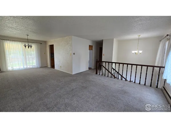 a open hall with a dining table chairs and a chandelier
