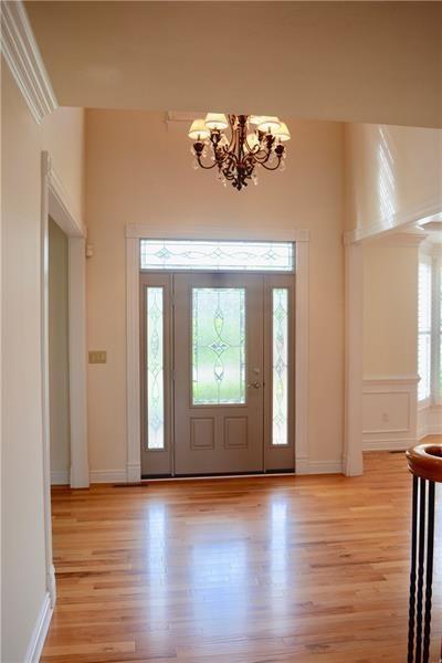 305 Scenic Court Coraopolis, PA 15108 - Photo 2 of 20 a view of an empty room with wooden floor and a window