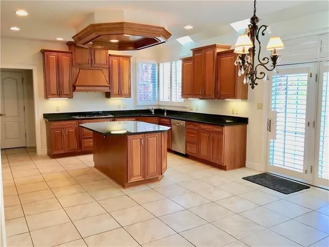 a kitchen with stainless steel appliances granite countertop a sink and cabinets